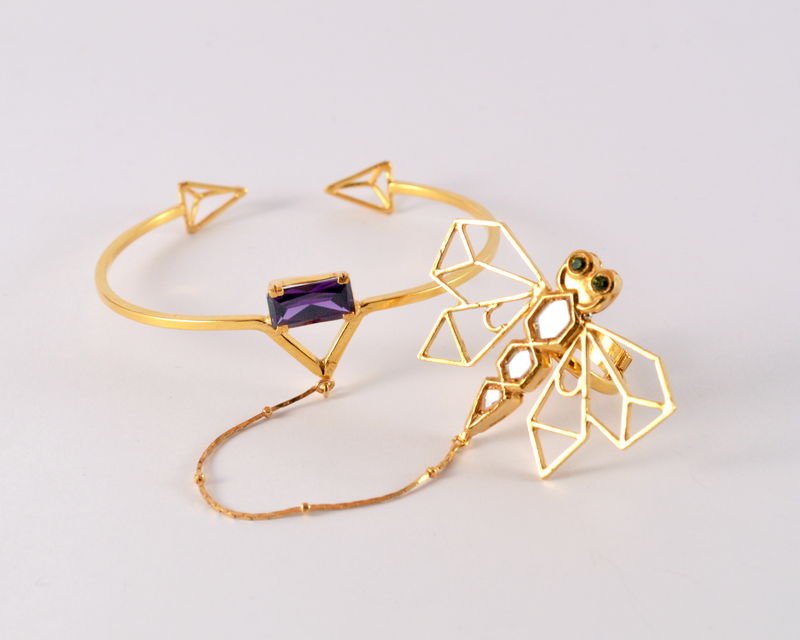 A Safari bangle set with a rectangular purple zircon, shown with an open-work kundan dragonfly ring.