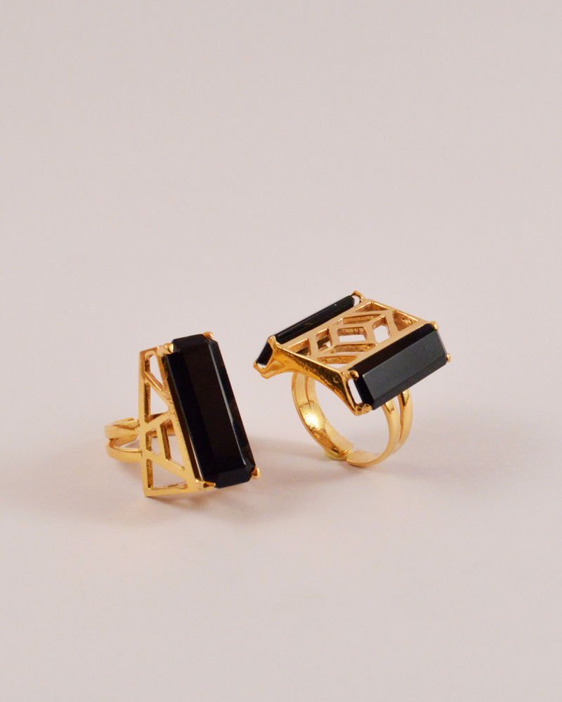 Two Statement Rings with rectangular black onyx bars held in gold-plated architectural cages.