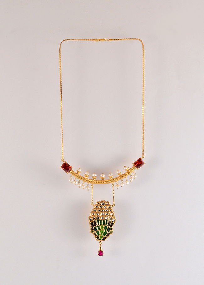 Snake head Necklace with Red zircon and pearl details, from the Safari collection.